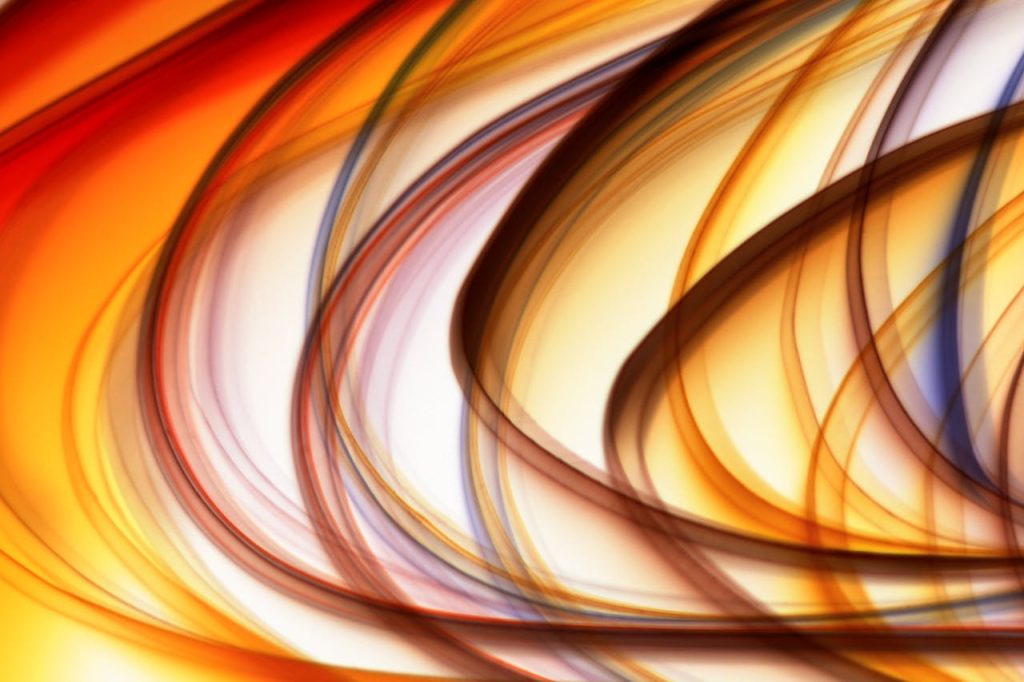 Vibrant abstract image featuring dynamic light swirls with warm colors.