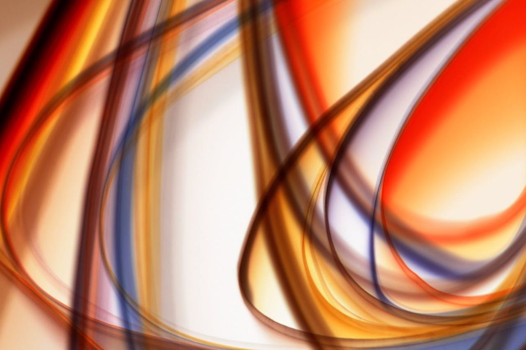 Colorful abstract composition with dynamic light streaks creating a vibrant visual effect.